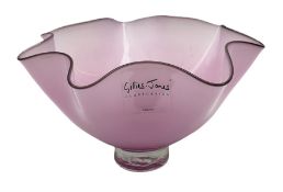 Gillies Jones pink glass bowl with crimped black rim upon a pedestal foot
