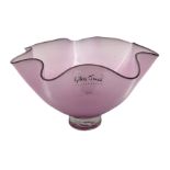 Gillies Jones pink glass bowl with crimped black rim upon a pedestal foot