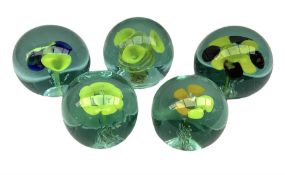 Five Victorian glass paperweights with flower inclusions