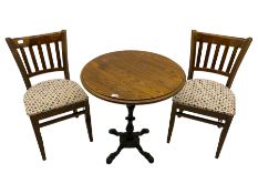 Pub table with circular top on cast ornate iron base; and two chairs