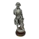Early 20th century polished spelter figure of 'Napoleon' in a standing pose beside a rock on simulat