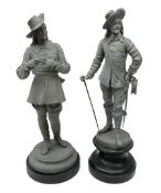 Matched pair of unpainted spelter figures of cavaliers - one standing removing his gloves