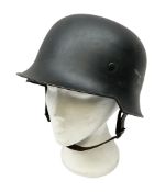 WW2 German steel combat helmet with eagle insignia to one side and U-724 to the other