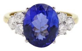 18ct gold oval tanzanite and six stone round brilliant cut diamond cluster ring