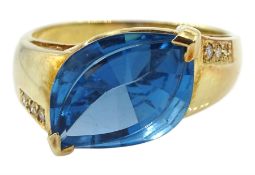 14ct gold marquise shaped London blue topaz ring with diamond set shoulders