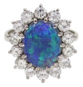 White gold oval black opal and round brilliant cut diamond cluster ring
