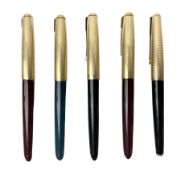Five Parker fountain pens with gold caps