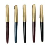 Five Parker fountain pens with gold caps