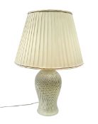 Cream table lamp of baluster form with lattice work body