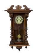 Small Spring driven German wall clock in a mahogany case with turned columns and pendants