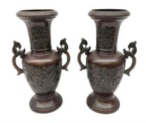 Pair of bronze Japanese vases of baluster form cast with birds amongst blossom and hoho bird handles