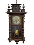 German wall clock in a mahogany vase with turned columns and finials