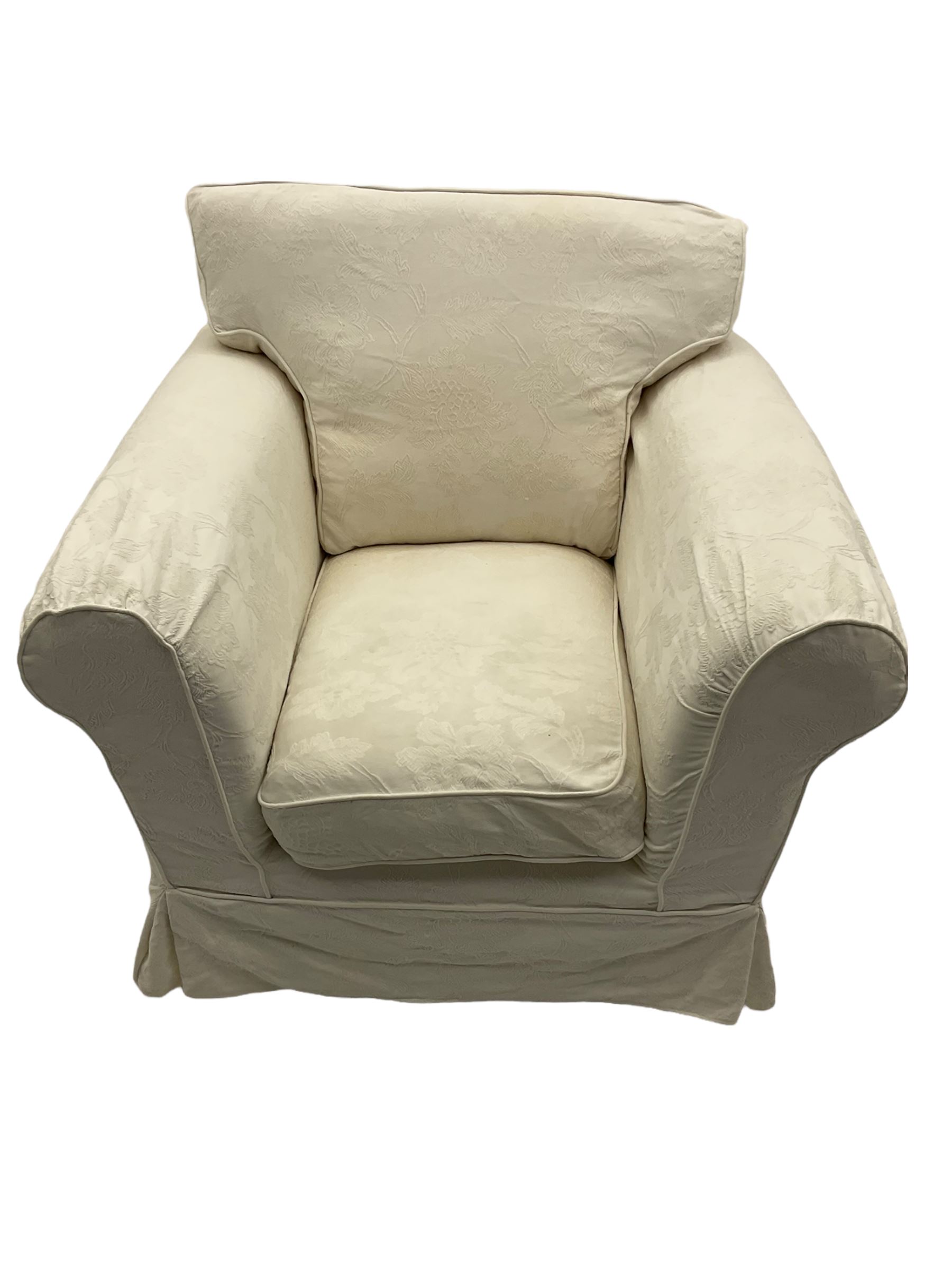 Traditional shaped armchair upholstered in white patterned loose cover