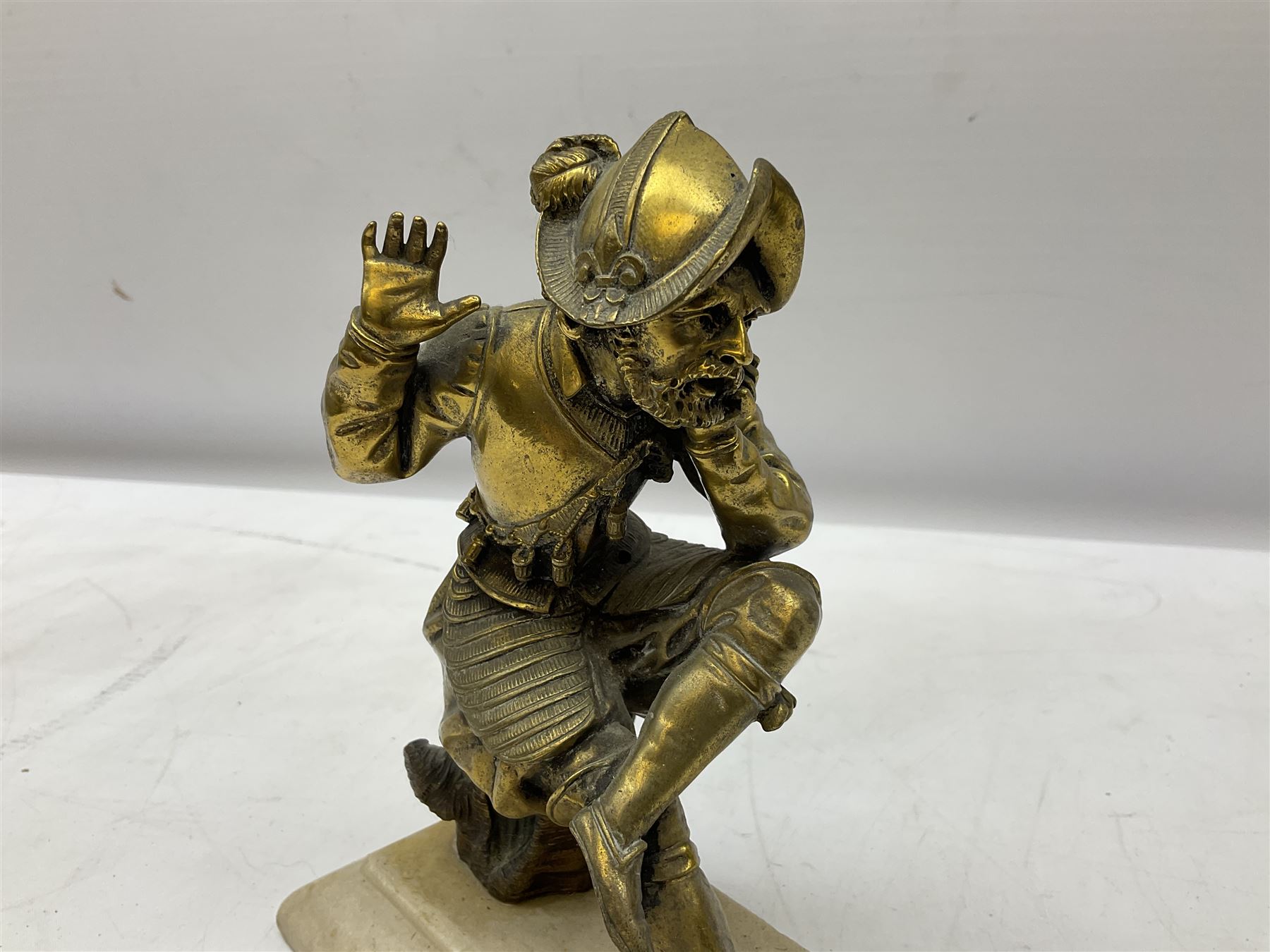 Brass figure of a knight seated up to a tree stump - Image 2 of 4