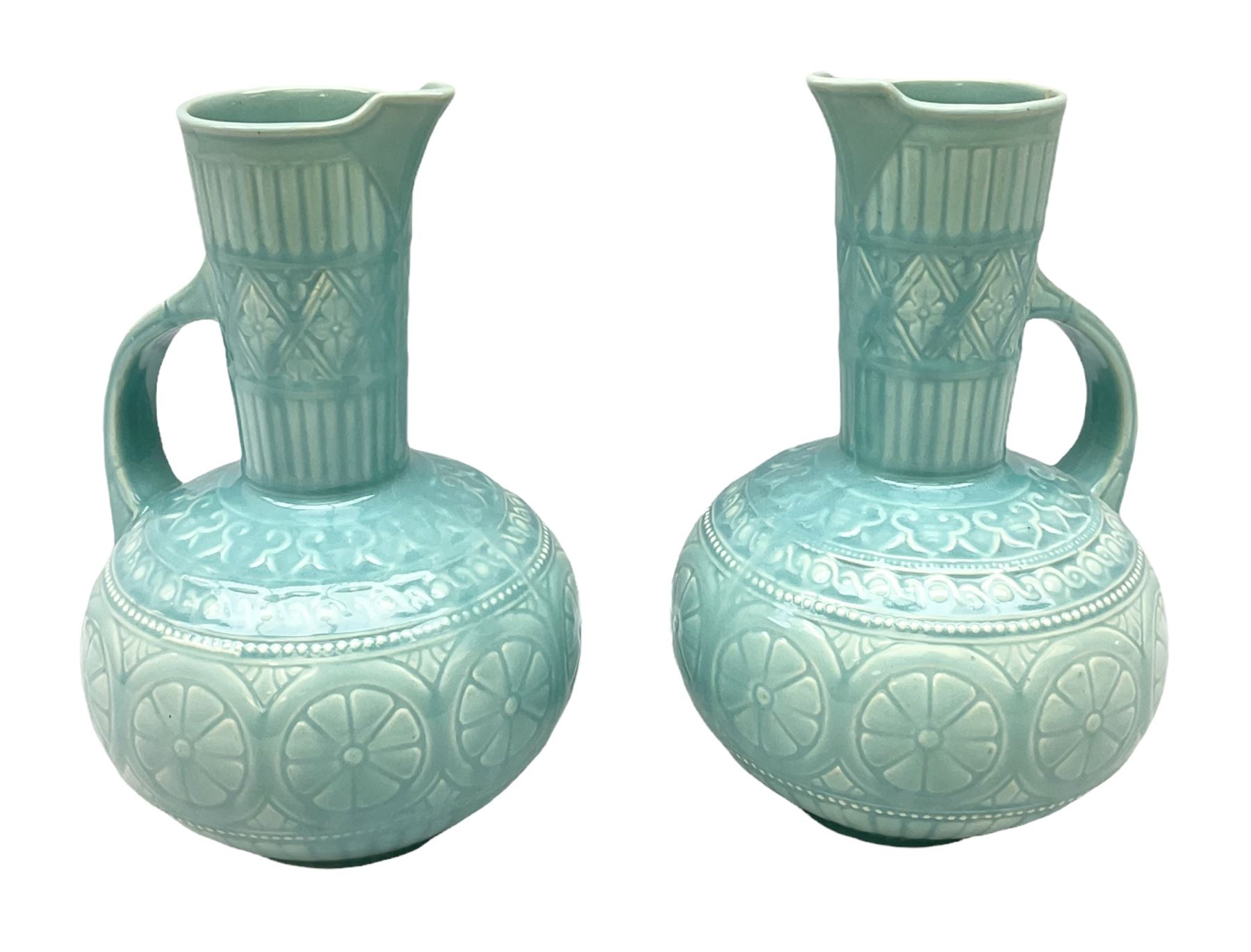 Pair of Lear pottery jugs with a blue ground and floral decoration