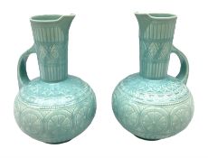 Pair of Lear pottery jugs with a blue ground and floral decoration