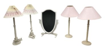 Four white / cream table lamps with pink shades and an ornate mirror of shield form