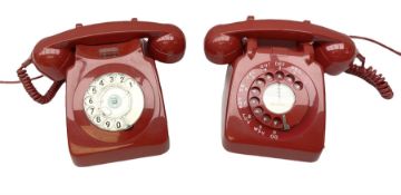 Two mid 19th century red telephones with rotary dials