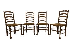 Four oak ladder back chairs with rush seats