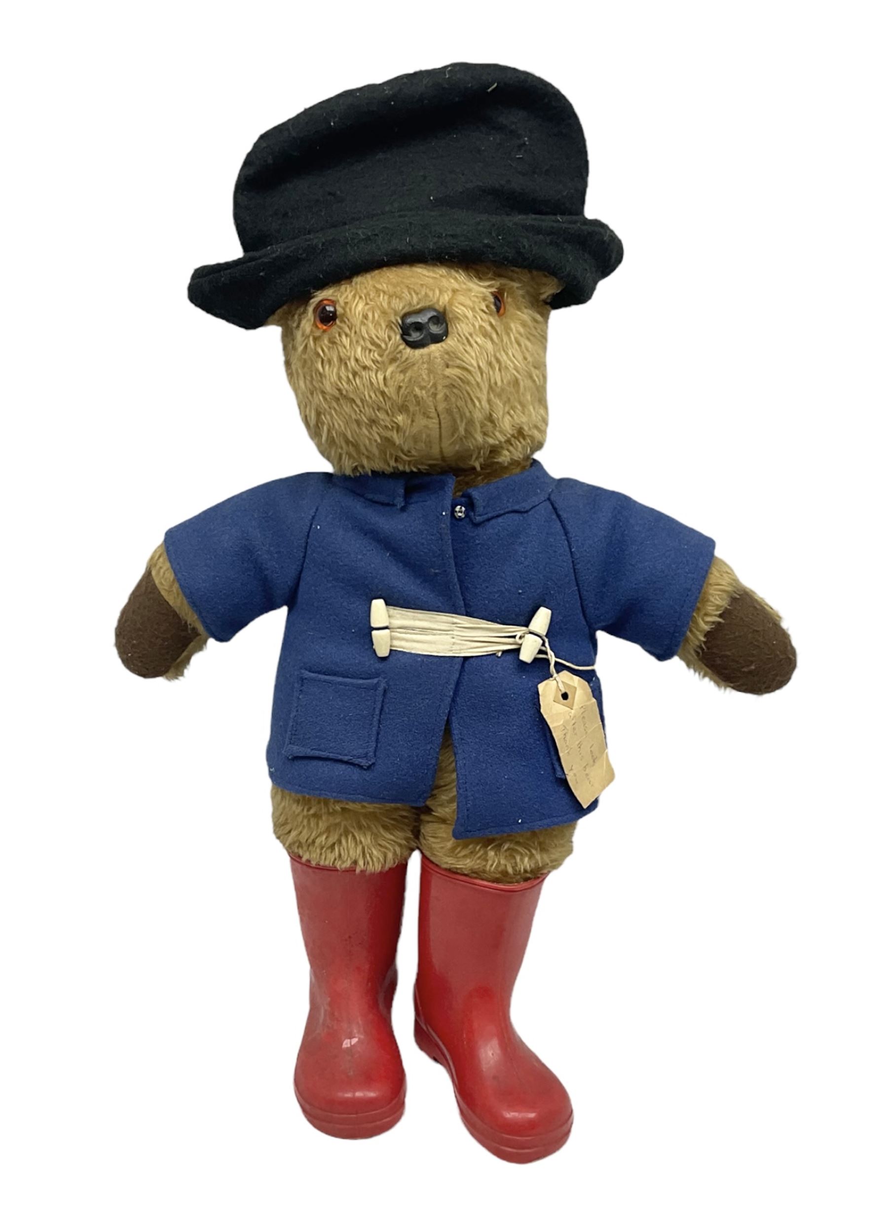 Paddington Bear in a blue felt jacket and black felt hat