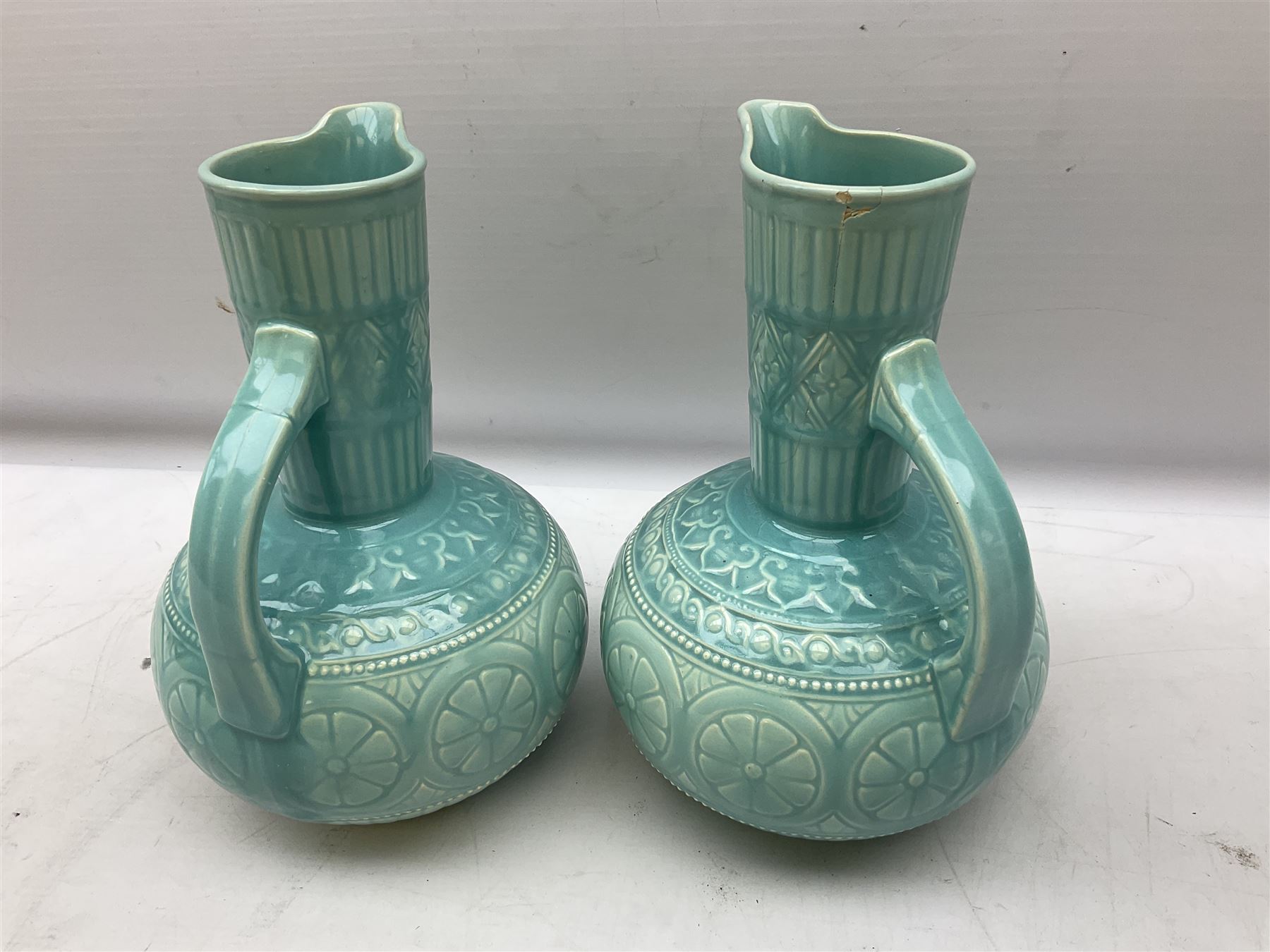 Pair of Lear pottery jugs with a blue ground and floral decoration - Image 4 of 6