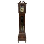 A late 20th century �Grandmother� clock in a figured mahogany veneered case with a break-arch hood a