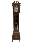 A late 20th century �Grandmother� clock in a figured mahogany veneered case with a break-arch hood a