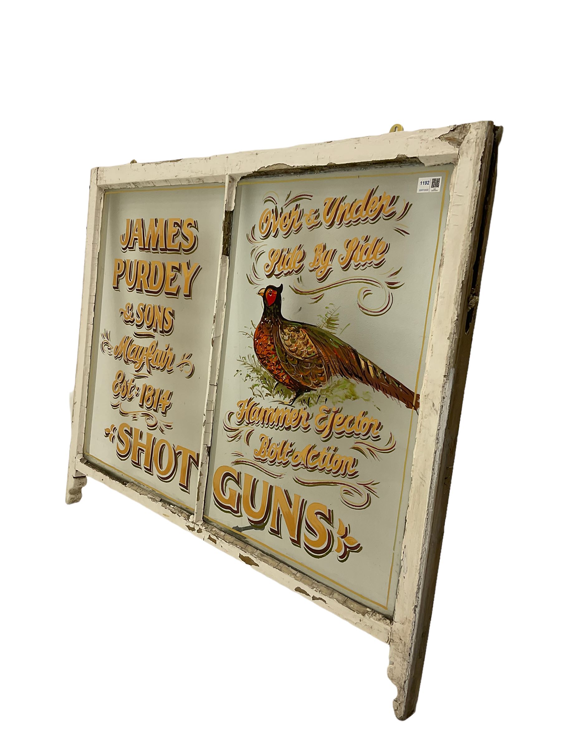 Late 19th century two pane sash window with later painted Purdy Shotguns advertising detail