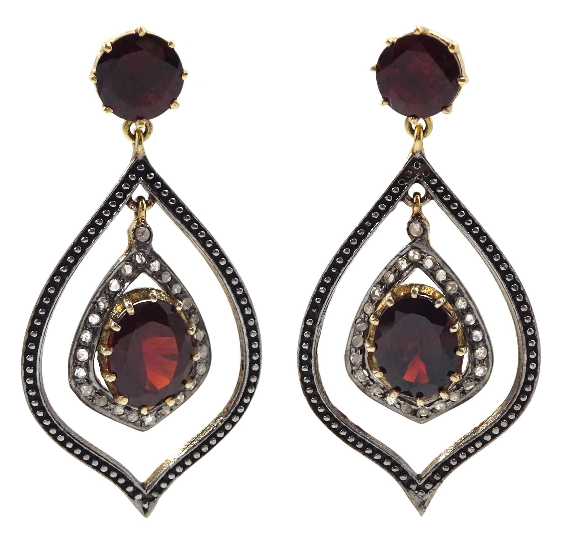 Pair of teardrop shaped oval and round garnet and diamond set pendant earrings