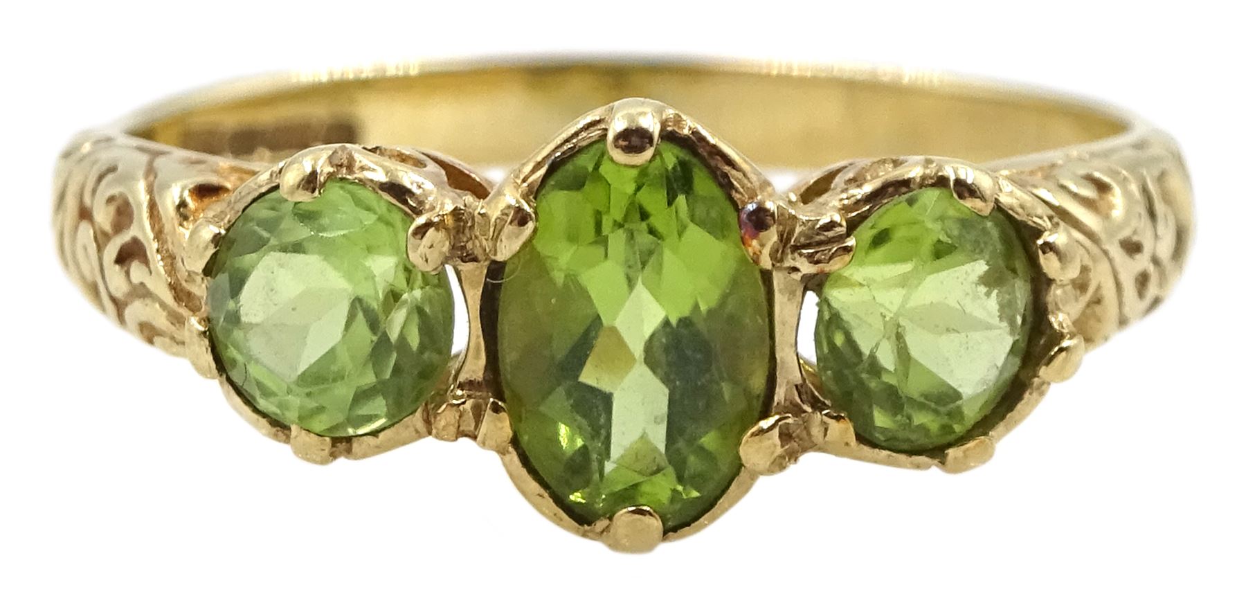 9ct gold three stone peridot ring with scroll design shoulders