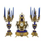 A 20th century continental gilt metal Lyre mantle clock with a pair of matching six light candelabra