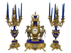 A 20th century continental gilt metal Lyre mantle clock with a pair of matching six light candelabra