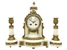 An early 20th century white marble mantle clock in a break front case with an arched top and finial