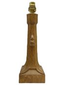 'Mouseman' tooled oak table lamp with tapered octagonal stem on leaf carved square base