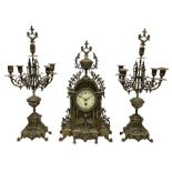 A late 19th century profusely decorated brass cased timepiece mantle clock with two matching five li