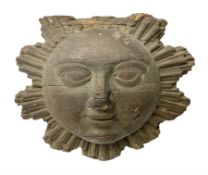 Carved pine mask of the sun