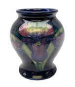 Mid 20th century Moorcroft vase of baluster form decorated in the Orchid pattern on blue ground