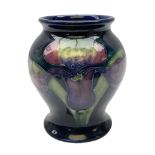 Mid 20th century Moorcroft vase of baluster form decorated in the Orchid pattern on blue ground