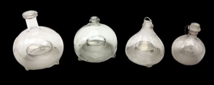 Four 19th century and later glass fly traps