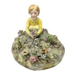 Crown Staffordshire figure modelled as a child in a garden