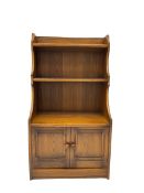 Ercol - medium elm bookcase fitted with two cupboards