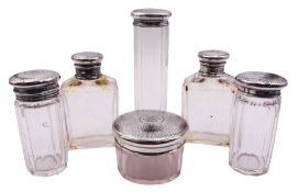 Set of six Edwardian glass dressing table jars with silver covers