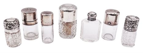 Seven glass scent bottles with silver covers