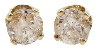 Pair of gold round brilliant cut diamond stud earrings
