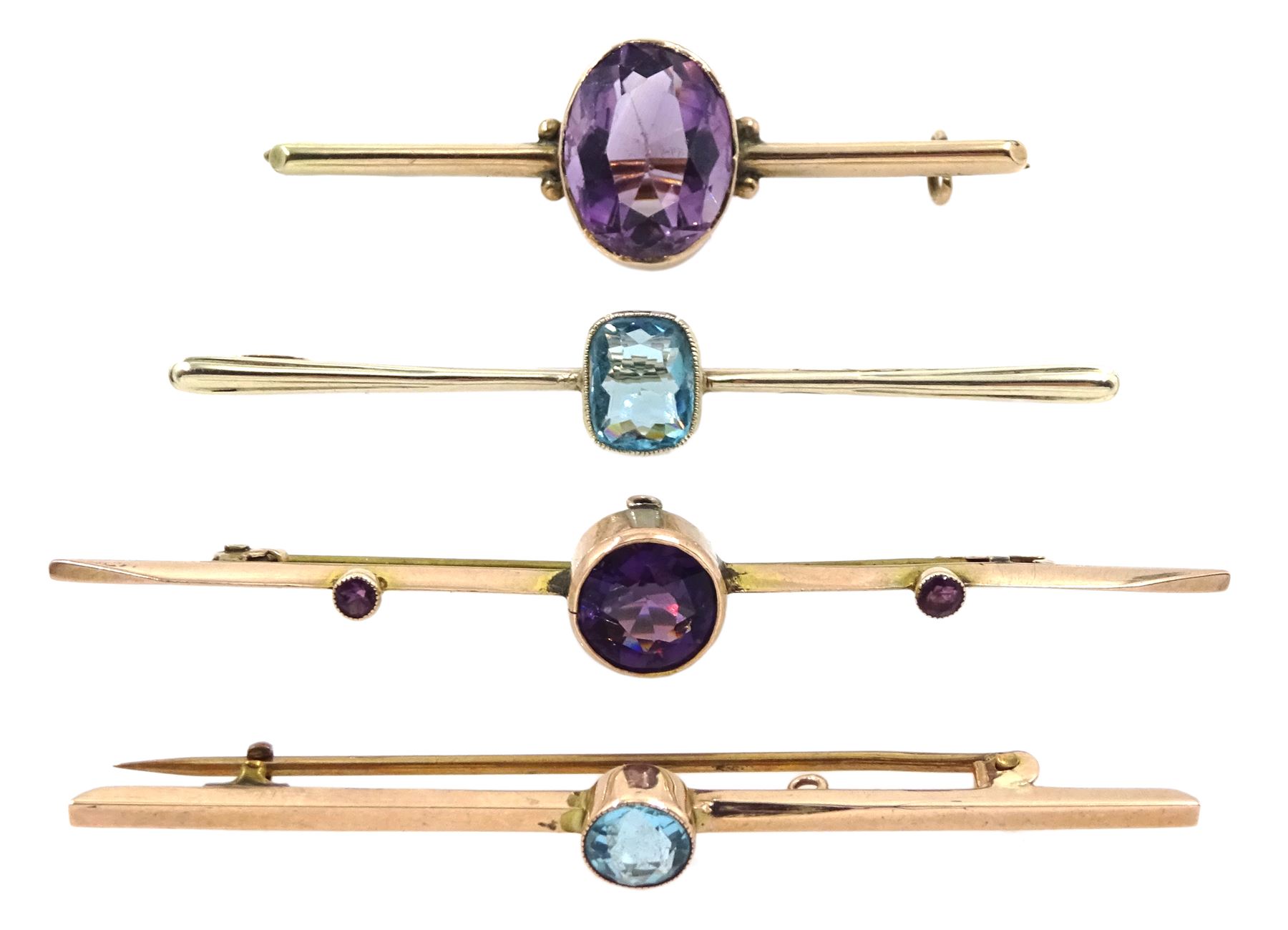 Two early 20th century gold amethyst brooches and two other 9ct gold blue stone set brooches