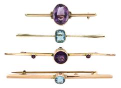 Two early 20th century gold amethyst brooches and two other 9ct gold blue stone set brooches