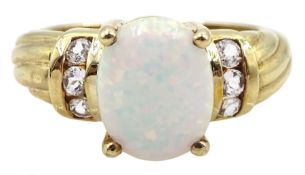 9ct gold single stone opal ring with white topaz shoulders