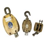 Three ship pulleys comprising wooden block double with swivel eye marked 'wooden block 240mm bduble