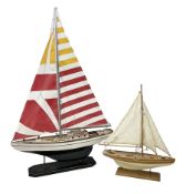 Wooden kit built model yacht with sails and mounted on wooden base