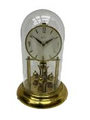 A mid-20th century �Bentima� 400-day anniversary torsion clock with a 7� circular brass base and une